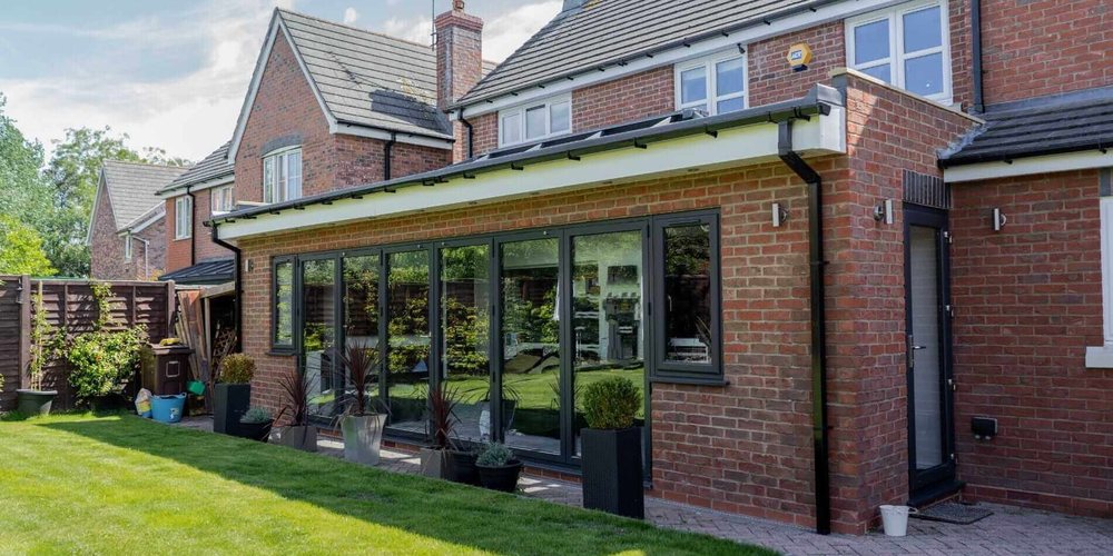 Single storey brick rear extension with grey bifold doors