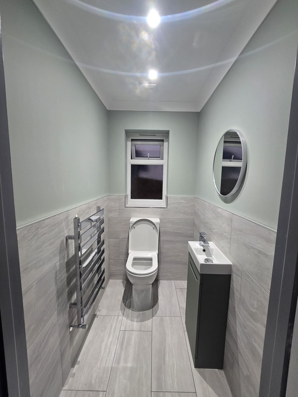 Freshly decorated cloakroom in sage green